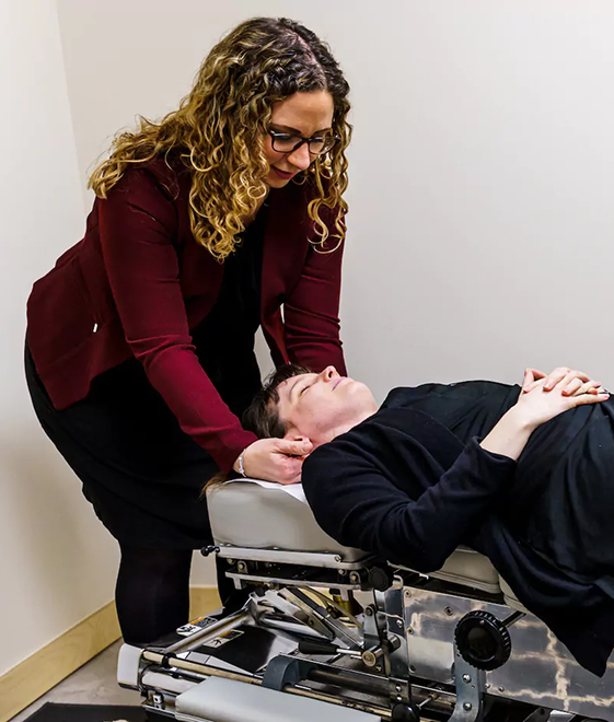 A Chiropractor doing an adjustment on a patient